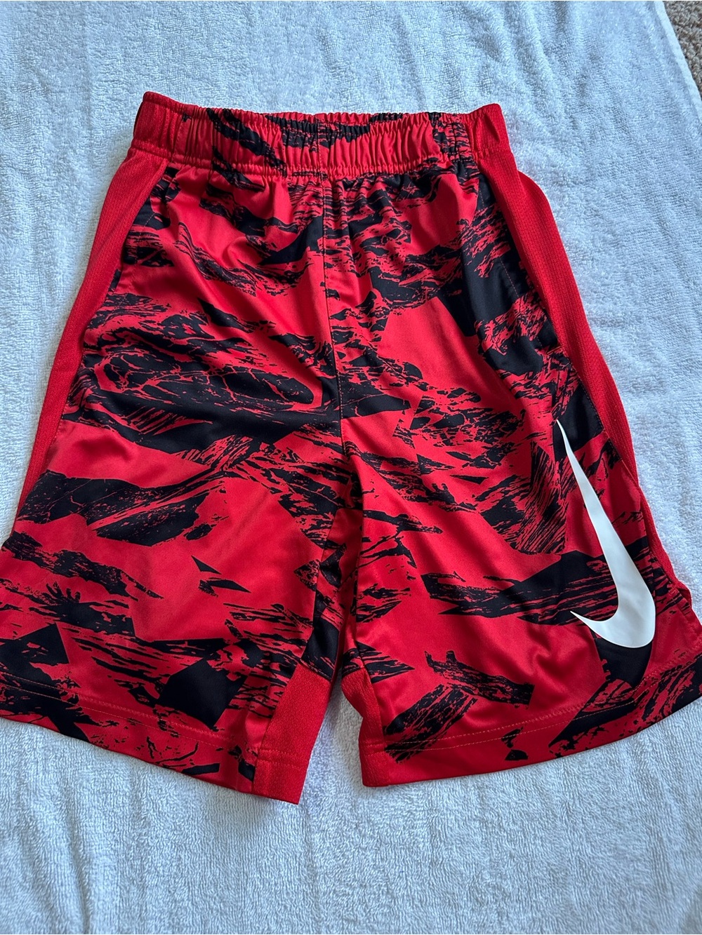 Nike Red Athletic Shorts with Black Accents and White Swoosh